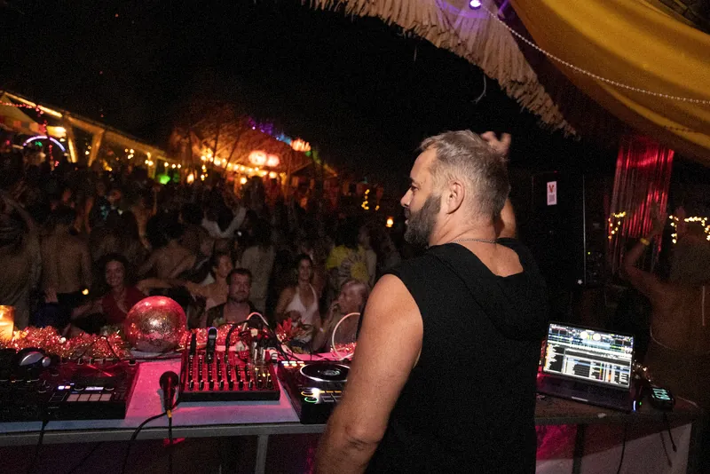 Tristan Gorski seen from behind the decks, watching a full dance floor
