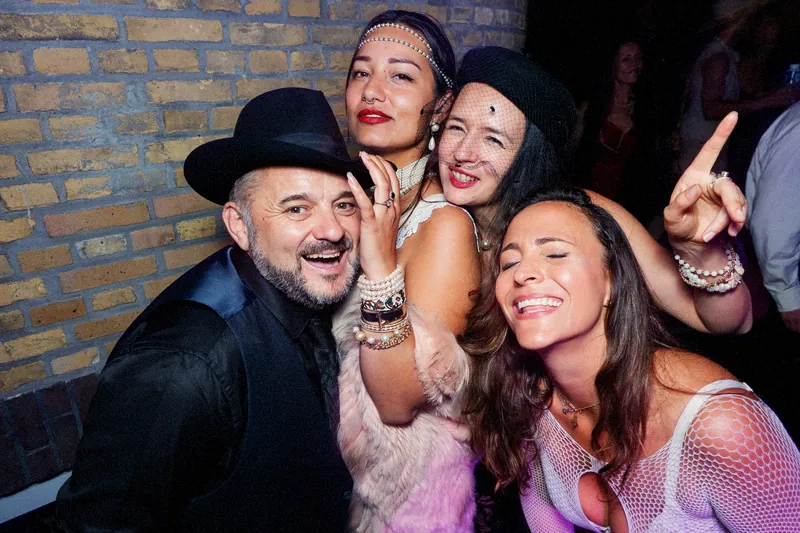 Tristan Gorski laughing with friends at a 1920s-themed party